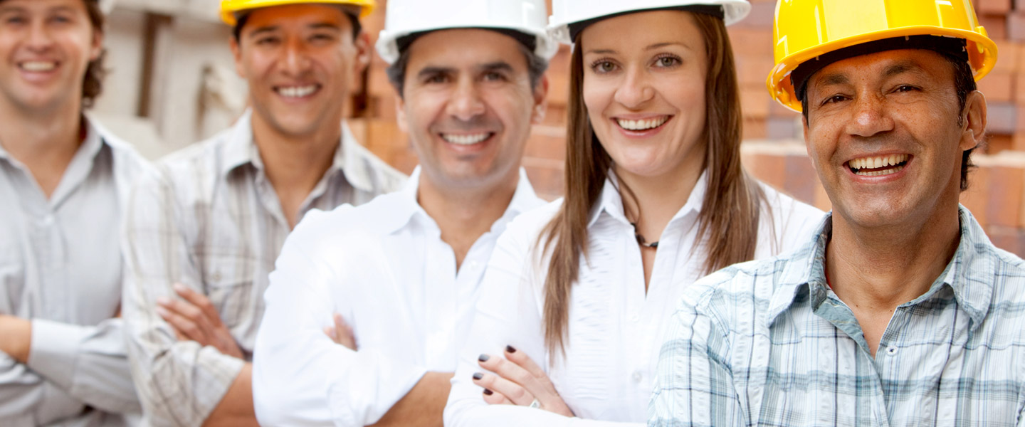 People with hardware hats on and smiling